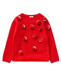 Red tricot jumper with coloured pom-poms