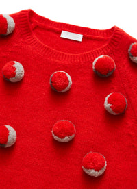 Red tricot jumper with coloured pom-poms