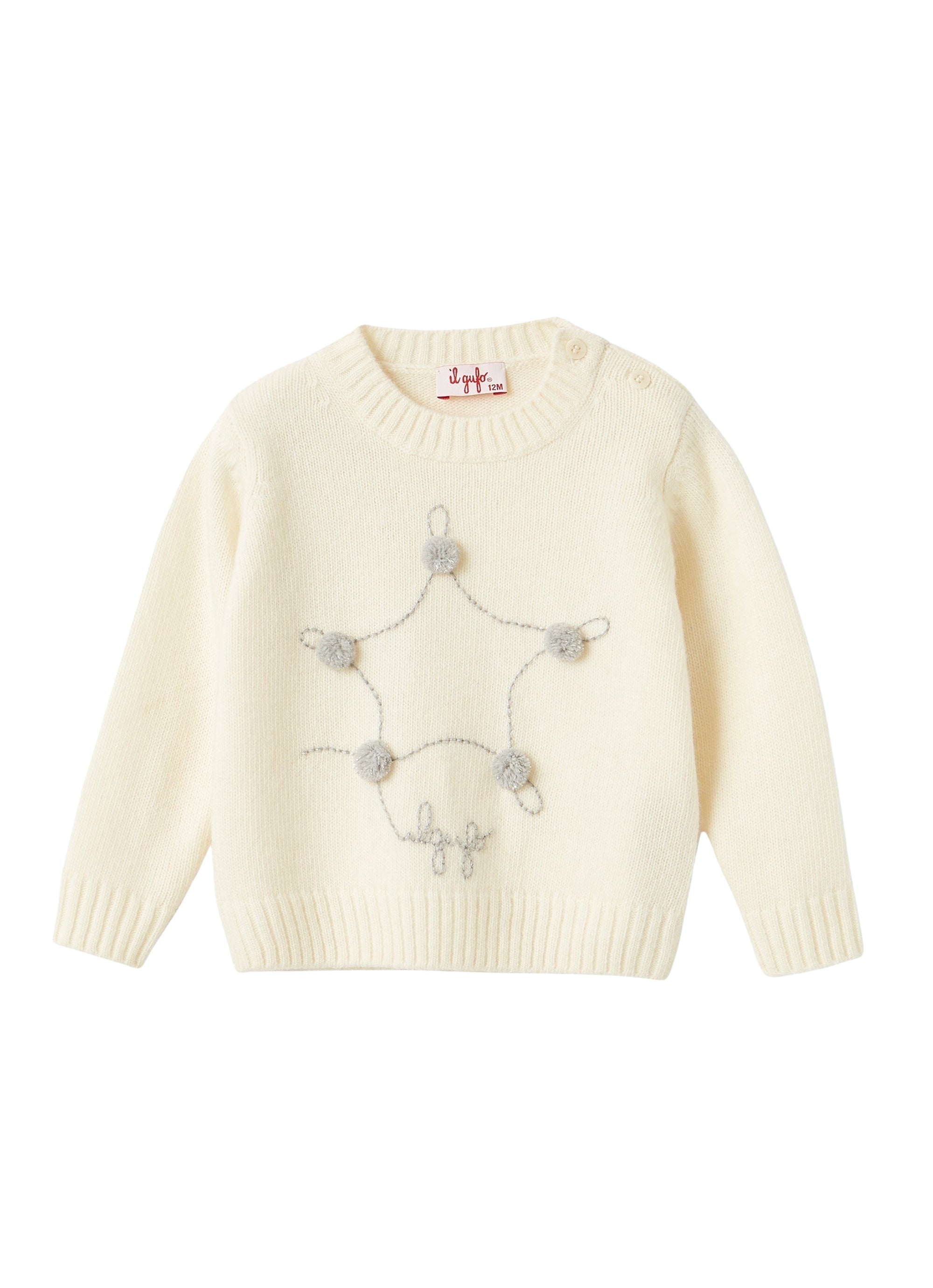 Maglione con stella ricamata e pom pon