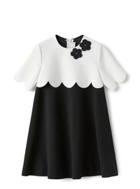 Dress in two different materials with flower embellishment