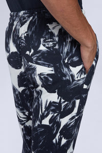 Pantalon avec revers imprimé fleurs noir et blanc