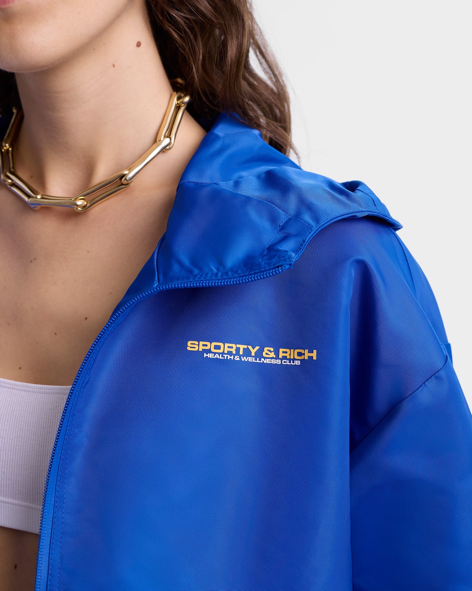 Veste coupe-vente à capuche Bold Health en satin - Paris Blue
