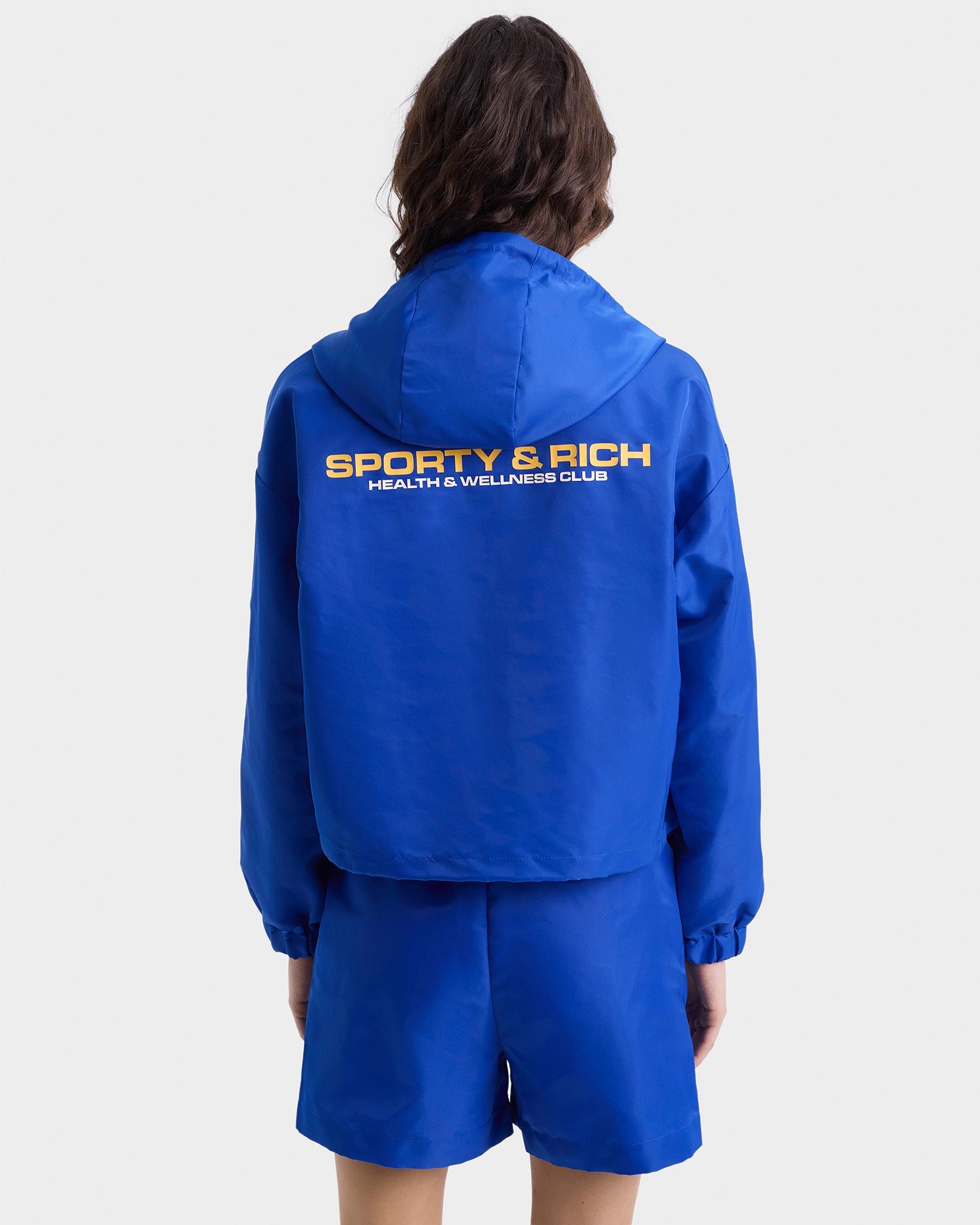 Veste coupe-vente à capuche Bold Health en satin - Paris Blue